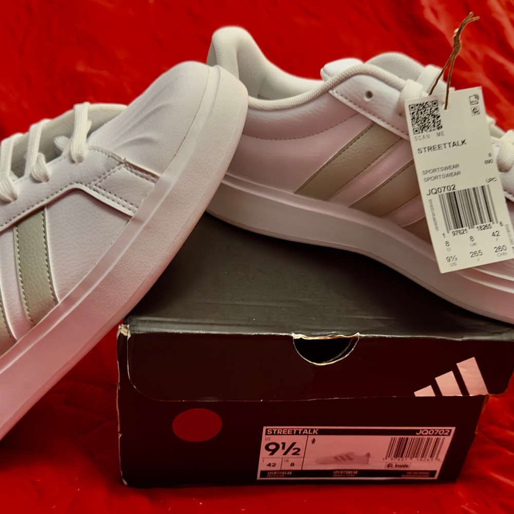 Adidas White Shoes with sage green stripes.